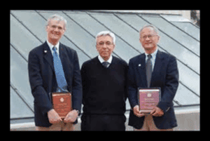 Academics holding books on a rooftop, symbolizing knowledge and freedom of speech, representing the core values of One Citizen Speaking and its focus on free speech and open dialogue.