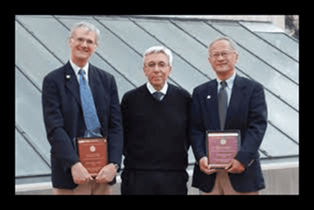 Academics holding books on a rooftop, symbolizing knowledge and freedom of speech, representing the core values of One Citizen Speaking and its focus on free speech and open dialogue.