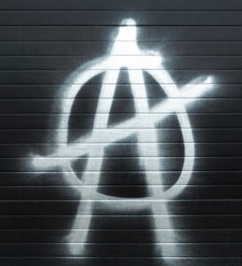Anti-establishment symbol spray-painted on a garage door, representing activism and free speech themes for onecitizenspeaking.com.