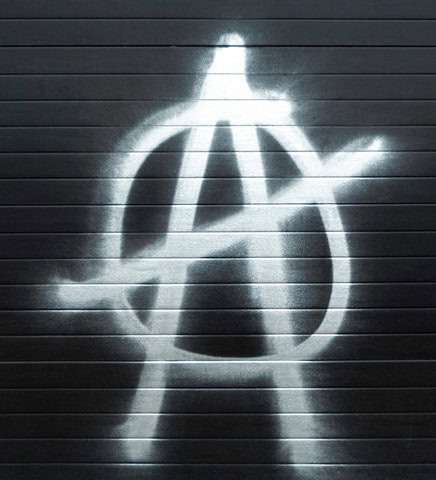Anti-establishment symbol spray-painted on a garage door, representing activism and free speech themes for onecitizenspeaking.com.