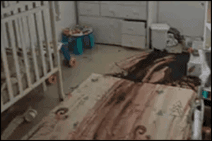 Messy baby nursery with scattered toys, bedding, and a playpen, showcasing a cluttered child's room. Perfect for discussions on home organization, parenting tips, or child safety.