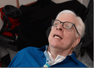 Inspiration speaker in a wheelchair speaking passionately at a conference, emphasizing advocacy and resilience.